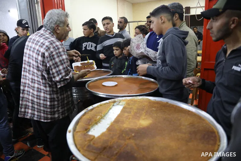 Masoud Al-Qatati, a Palestinian man sells sweets low prices and sometimes free for customers due to the difficult economic conditions of the residents of the Gaza Strip, in Gaza city on November 23, 2021. Al-Qatati said...