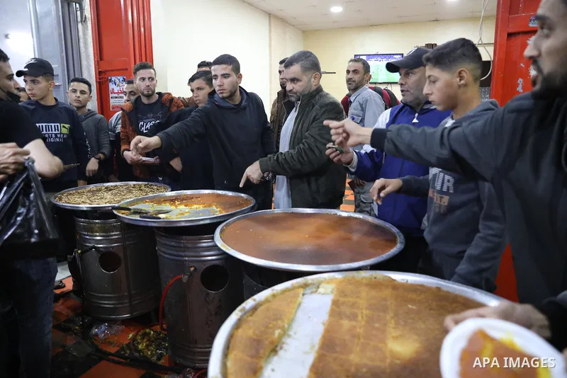 Masoud Al-Qatati, a Palestinian man sells sweets low prices and sometimes free for customers due to the difficult economic conditions of the residents of the Gaza Strip, in Gaza city on November 23, 2021. Al-Qatati said...