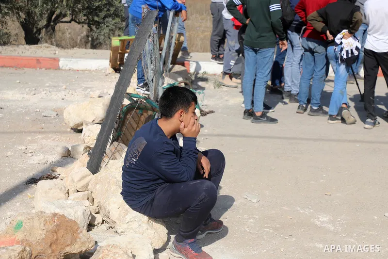 Israeli forces and Palestinian demonstrators clash in the village of al-Lubban al-Sharqiya in the Israeli-occupied West Bank on November 25, 2021. Photo by Wajed Nobani