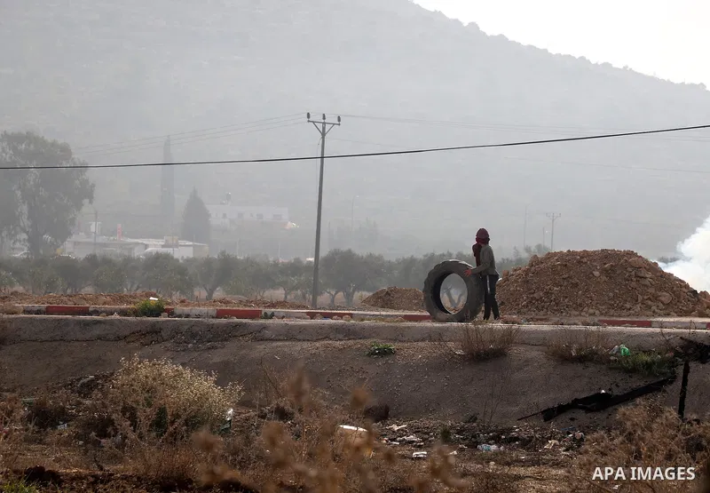 Israeli forces and Palestinian demonstrators clash in the village of al-Lubban al-Sharqiya in the Israeli-occupied West Bank on November 25, 2021. Photo by Wajed Nobani