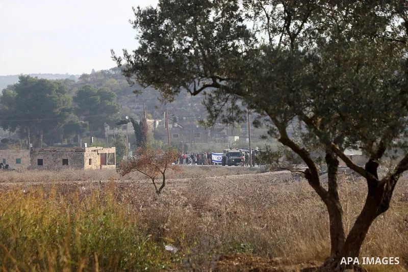 Israeli forces and Palestinian demonstrators clash in the village of al-Lubban al-Sharqiya in the Israeli-occupied West Bank on November 25, 2021. Photo by Wajed Nobani