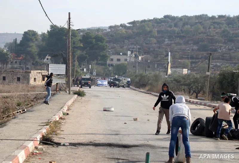 Israeli forces and Palestinian demonstrators clash in the village of al-Lubban al-Sharqiya in the Israeli-occupied West Bank on November 25, 2021. Photo by Wajed Nobani