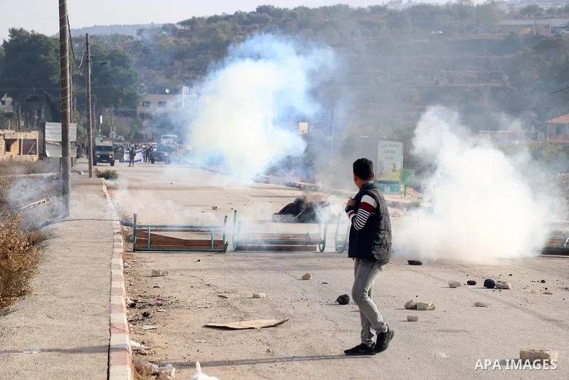 Israeli forces and Palestinian demonstrators clash in the village of al-Lubban al-Sharqiya in the Israeli-occupied West Bank on November 25, 2021. Photo by Wajed Nobani