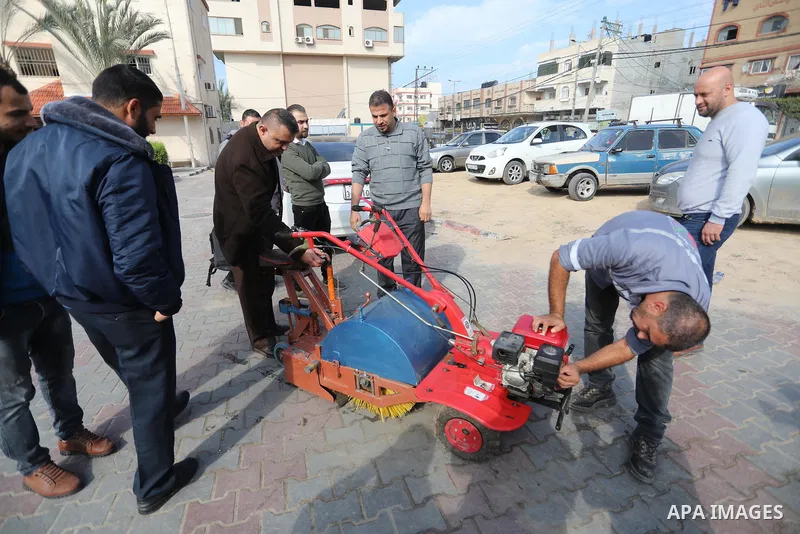 Palestinian engineers invent a street sweeping machine, in Deir al-Balah, in the center of Gaza strip, on November 25, 2021. Engineers invented a machine for sweeping and cleaning streets to facilitate the work of cleane...