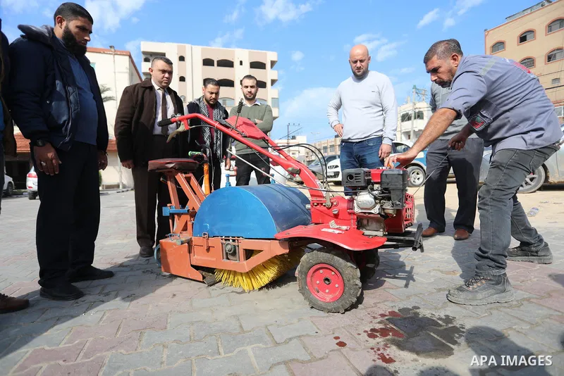 Palestinian engineers invent a street sweeping machine, in Deir al-Balah, in the center of Gaza strip, on November 25, 2021. Engineers invented a machine for sweeping and cleaning streets to facilitate the work of cleane...