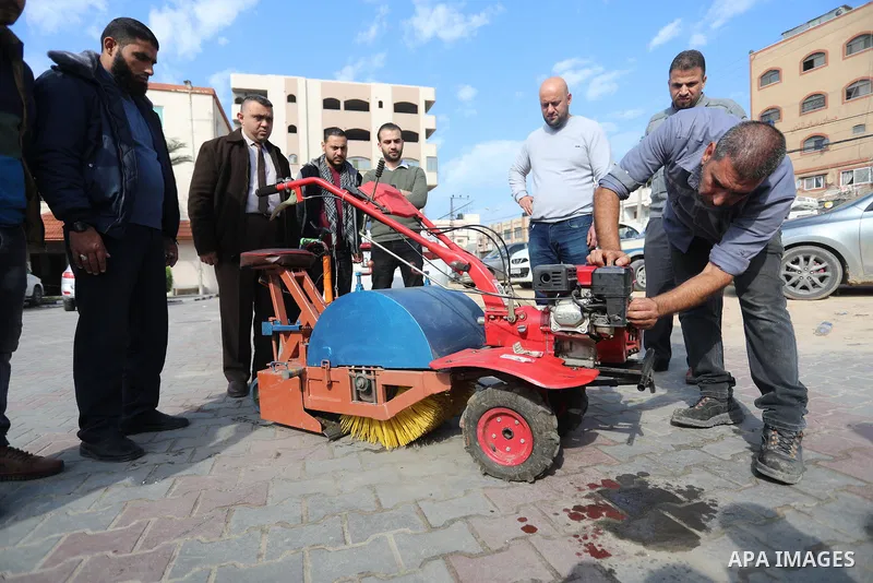 Palestinian engineers invent a street sweeping machine, in Deir al-Balah, in the center of Gaza strip, on November 25, 2021. Engineers invented a machine for sweeping and cleaning streets to facilitate the work of cleane...