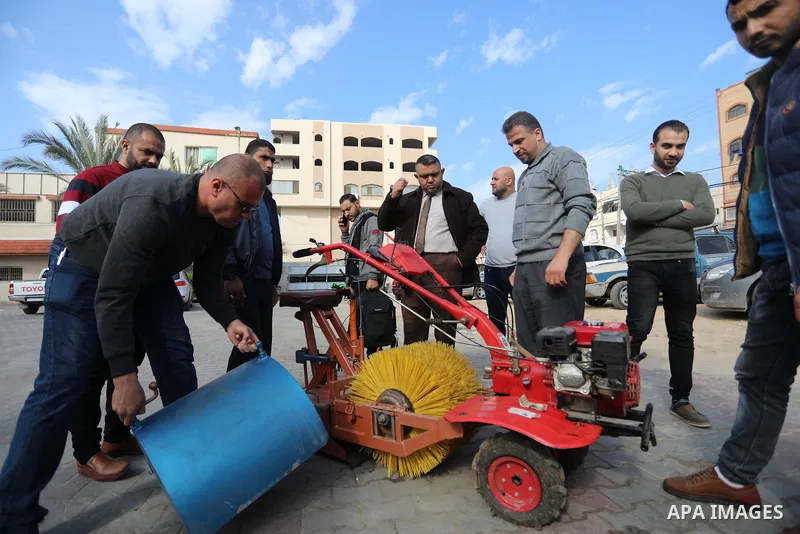 Palestinian engineers invent a street sweeping machine, in Deir al-Balah, in the center of Gaza strip, on November 25, 2021. Engineers invented a machine for sweeping and cleaning streets to facilitate the work of cleane...