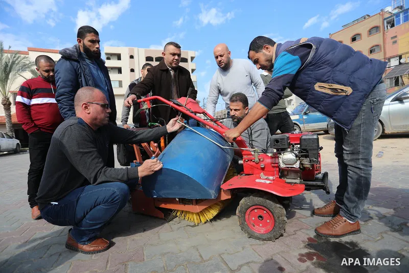 Palestinian engineers invent a street sweeping machine, in Deir al-Balah, in the center of Gaza strip, on November 25, 2021. Engineers invented a machine for sweeping and cleaning streets to facilitate the work of cleane...