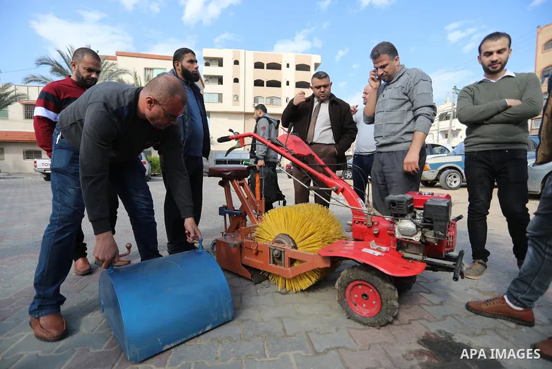 Palestinian engineers invent a street sweeping machine, in Deir al-Balah, in the center of Gaza strip, on November 25, 2021. Engineers invented a machine for sweeping and cleaning streets to facilitate the work of cleane...