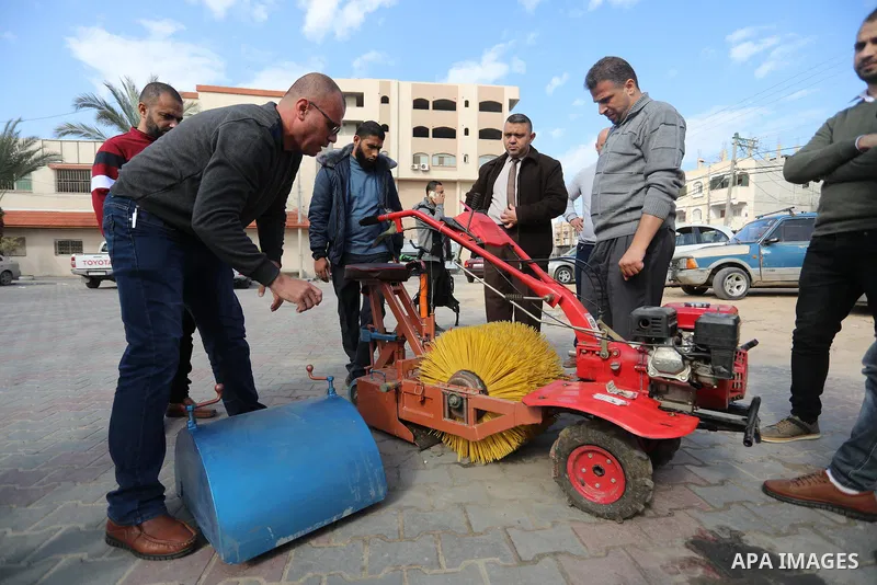Palestinian engineers invent a street sweeping machine, in Deir al-Balah, in the center of Gaza strip, on November 25, 2021. Engineers invented a machine for sweeping and cleaning streets to facilitate the work of cleane...