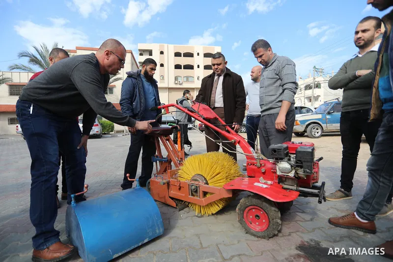 Palestinian engineers invent a street sweeping machine, in Deir al-Balah, in the center of Gaza strip, on November 25, 2021. Engineers invented a machine for sweeping and cleaning streets to facilitate the work of cleane...