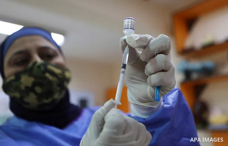Palestinian students receive the first dose of COVID-19 vaccine during a vaccination campaign, at a school in the West Bank of Hebron on Nobember 25, 2021. Photo by Mamoun Wazwaz