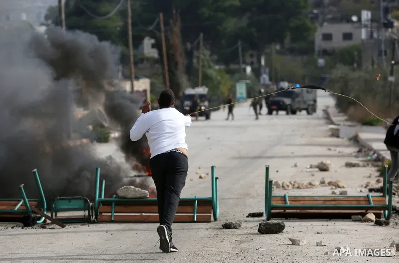 Israeli forces and Palestinian demonstrators clash in the village of al-Lubban al-Sharqiya in the Israeli-occupied West Bank on November 25, 2021. Photo by Ayman Ameen