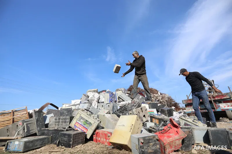 A Palestinian worker sorts through electronic waste such as batteries, a popular product in the midst of Gaza’s electricity crisis, after Israeli authorities prevented the export of 25,000 tons of damaged batteries, in J...