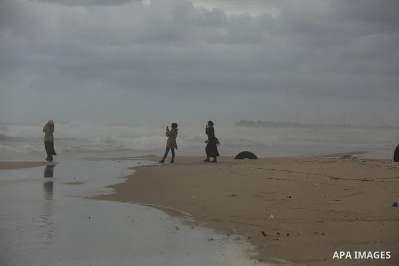 Palestinians show as they in their daily lifes during a rainy day, in Gaza City December 01, 2021. A low-pressure front is expected to affect Palestine today, thus weather conditions are set to be partly cloudy to cloudy...