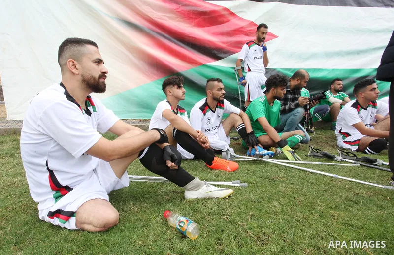 Palestinian amputees using crutches play a football match during a training organized by the Red Cross at Palestine Stadium in Gaza city, on December 2021. Almost 50,000 Palestinians are classified as "disabled" among th...