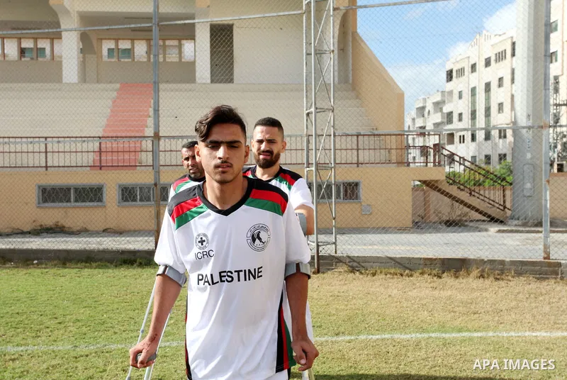 Palestinian amputees using crutches play a football match during a training organized by the Red Cross at Palestine Stadium in Gaza city, on December 2021. Almost 50,000 Palestinians are classified as "disabled" among th...