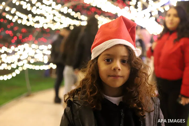 Palestinian Christian shop at Christmas market in the West Bank city of Ramallah, on December 03 2021 as Christians prepare to celebrate Christmas. Photo by Wajed Nobani