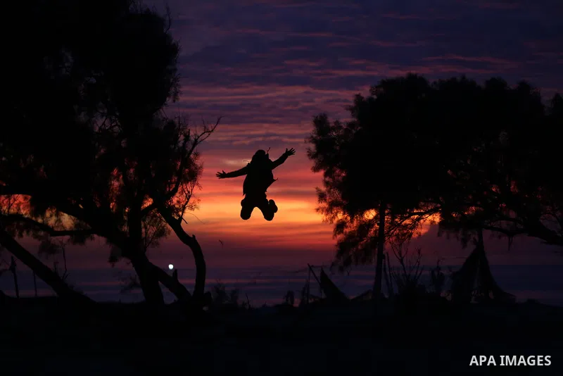 Palestinians enjoy the beach along the shore of the Mediterranean Sea during the sunset in Deir al-Balah in the central Gaza Strip on December 04, 2021. Photo by Ashraf Amra