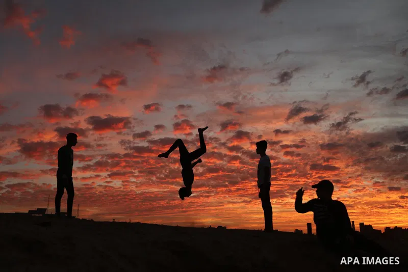 Palestinians practis parkour during sunset in Gaza city on December 4, 2021. Photo by Osama Baba