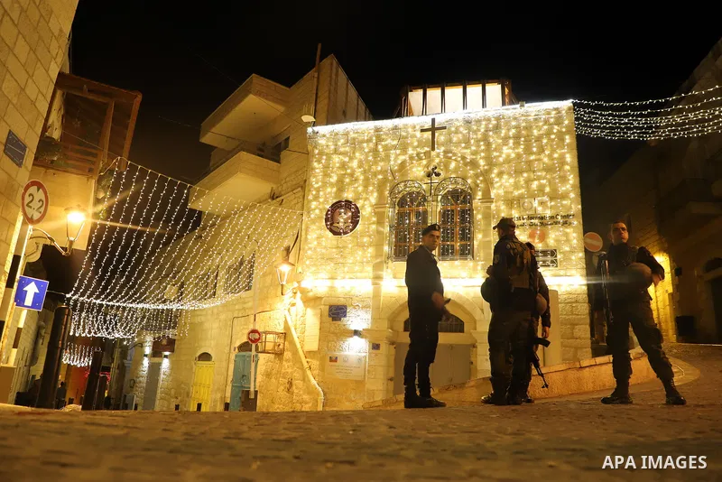 Palestinians light Christmas tree in Manger Square outside the Church of the Nativity in the West Bank city of Bethlehem on December 4, 2021. Christmas is an annual festival commemorating the birth of Jesus Christ, obser...
