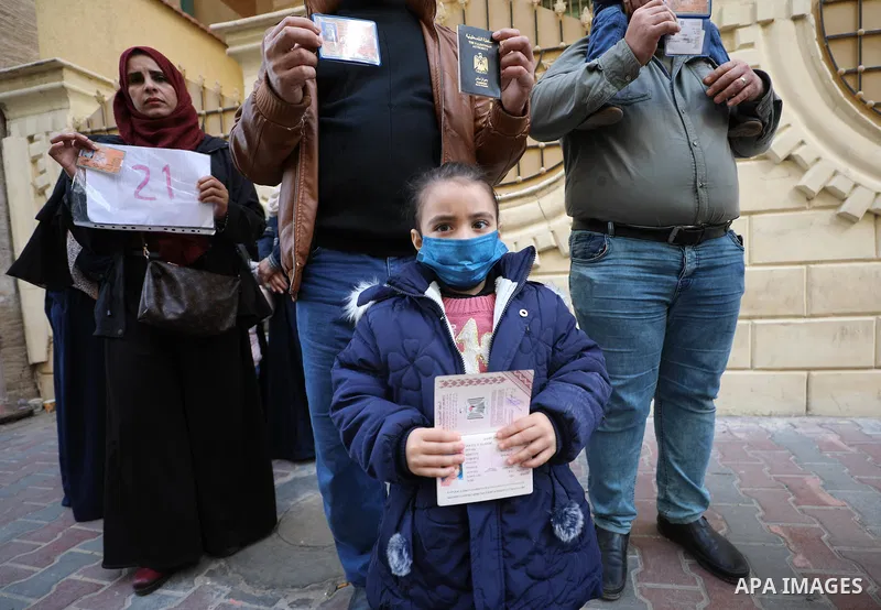 Palestinians hold IDs and banners to demand of the family reunification, in Gaza city on 06 December 2021.Thousands of Palestinians have suffered as a result of the law, which the Israeli government claims was enacted fo...