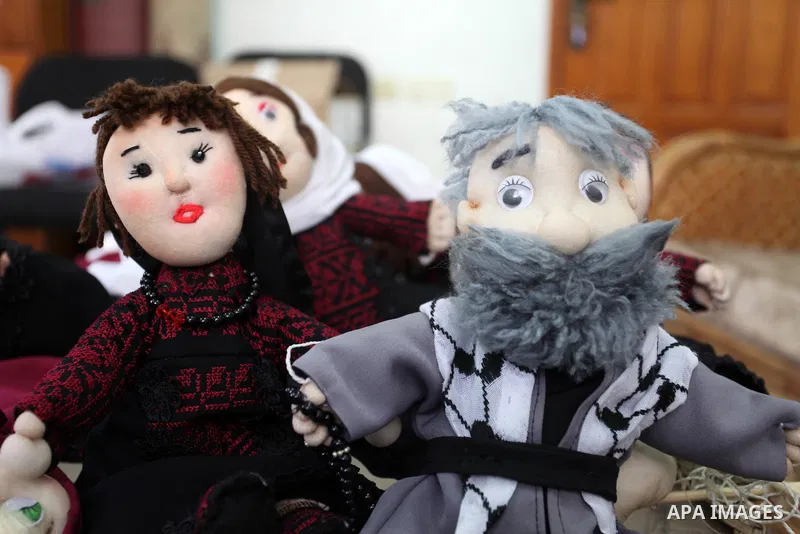 Palestinian woman Wala' Mousa makes dolls depicting Palestinian heritage in the Nuseirat camp in the central Gaza Strip on December 6, 2021. Palestinians enjoy a rich cultural heritage. The Palestinian people have lived...