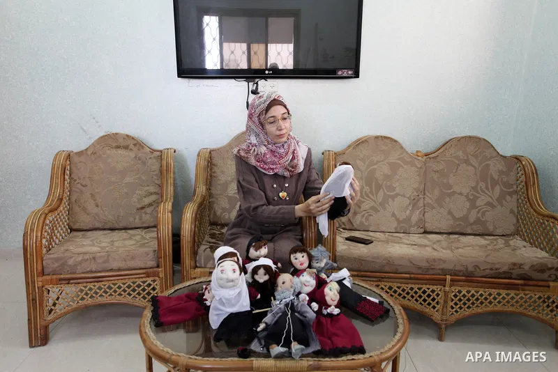 Palestinian woman Wala' Mousa makes dolls depicting Palestinian heritage in the Nuseirat camp in the central Gaza Strip on December 6, 2021. Palestinians enjoy a rich cultural heritage. The Palestinian people have lived...