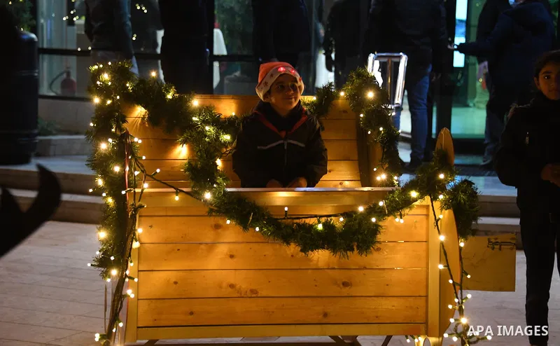 Palestinians attend a Christmas tree lighting in the West Bank city of Ramallah on December 6, 2021. Photo by Prime Minister Office