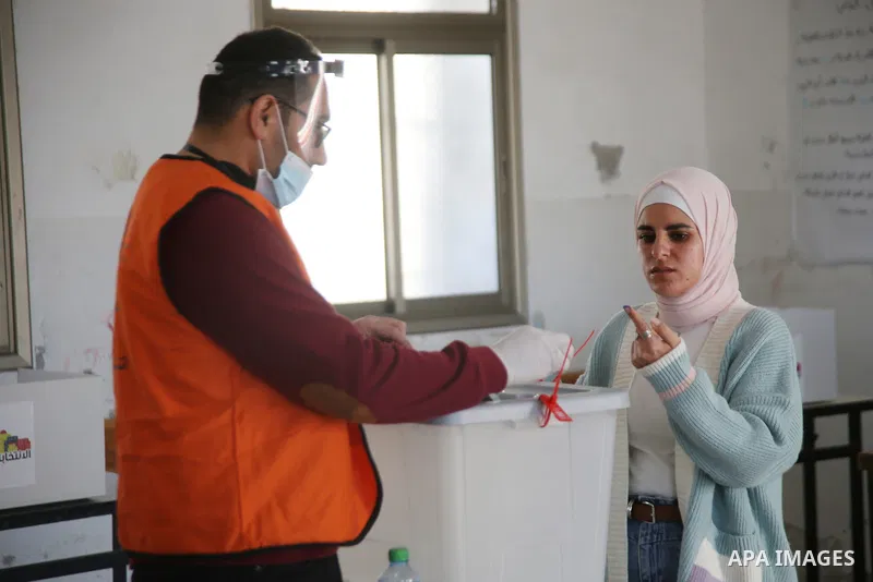 Palestinian voters cast their vote in the first phase of local elections in the in village of Surra in the western West Bank, on December 12, 2021. Polls opened this morning for the first phase of local elections at 154...