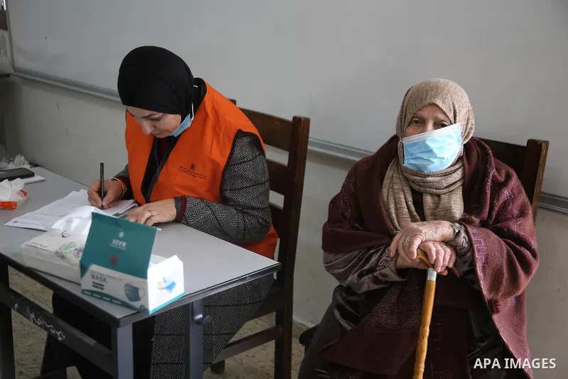 Palestinian voters cast their vote in the first phase of local elections in the in village of Surra in the western West Bank, on December 12, 2021. Polls opened this morning for the first phase of local elections at 154...