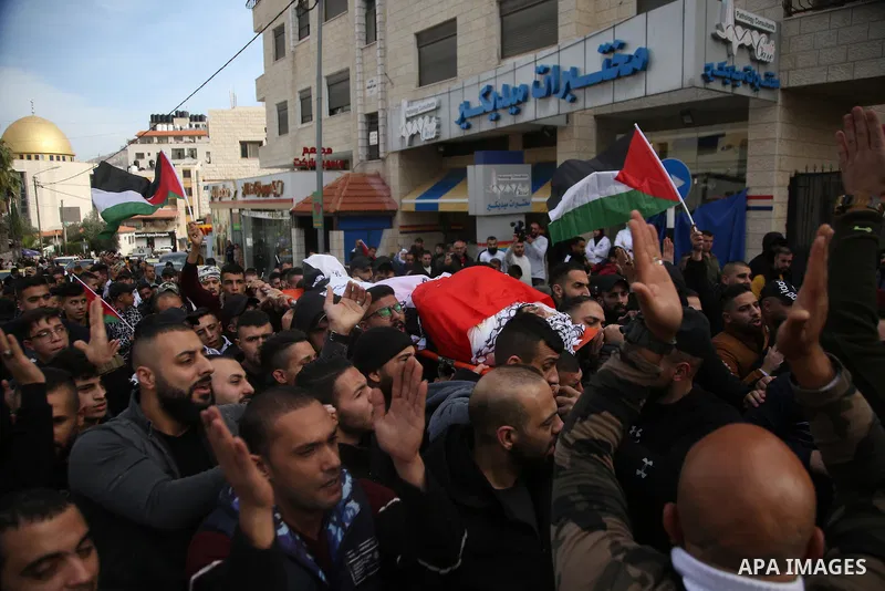 Palestinians carry the body of Jameel al-Kayyal, who was killed by Israeli soldiers, during his funeral in the West Bank city of Nablus on December 13, 2021. Israeli forces Monday killed a Palestinian youth and injured t...