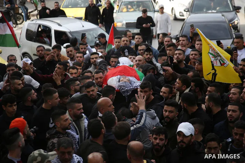 Palestinians carry the body of Jameel al-Kayyal, who was killed by Israeli soldiers, during his funeral in the West Bank city of Nablus on December 13, 2021. Israeli forces Monday killed a Palestinian youth and injured t...