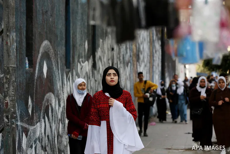 A Palestinian girl wearing traditional dress creation during a protest pause in response to the Israel theft of Palestinian heritage and national dress, in Gaza city on December 16, 2021. UNESCO has added a series of art...