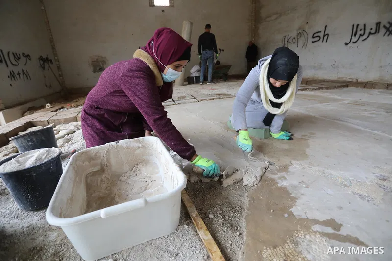 Volunteers and archaeologists restore the floor of the Byzantine church mosaic, in Khan Younis in the southern Gaza Strip, on December 20, 2021. The Iwan Center for Cultural Heritage at the Islamic University, in coopera...