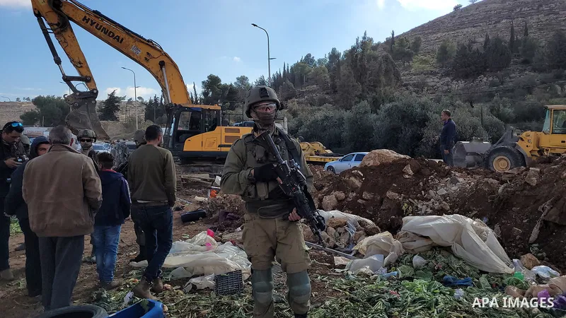 An Israeli bulldozer razes Palestinian agricultural lands in al-Hijri village south of Hebron in the West Bank, on December 22, 2021. According to a report by the Israeli human rights group B’Tselem, the Israeli High Cou...