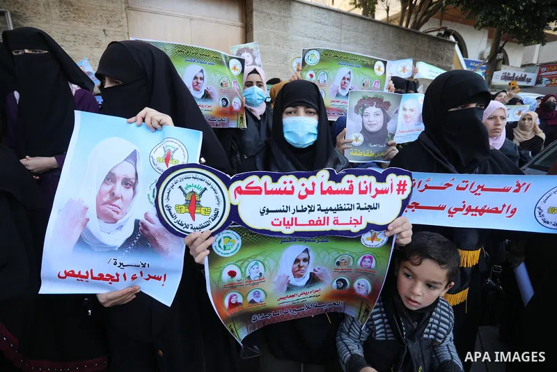 Supporters of Palestinian Islamic Jihad take part in a protest to show solidarity with female prisoners held in Israeli jails, in front of Red Cross office, in Gaza city, 22 December 2021. The female prisoners embarked m...