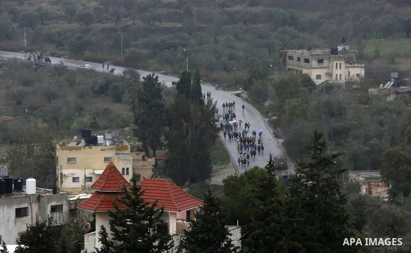 Israeli settlers return back to the illegal Israeli outpost of Homesh, after a confronting Palestinians protesting their return to the area in the West Bank village of Burqah, on December 23, 2021. - Palestinian men are...