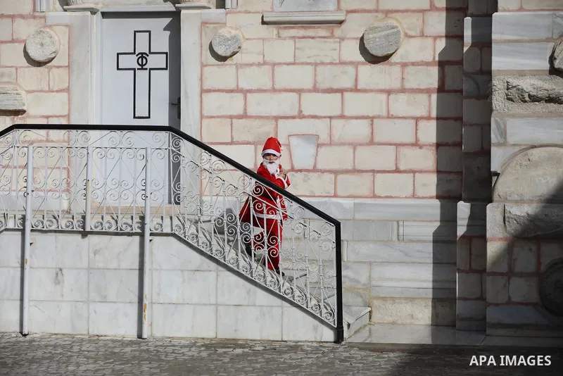 Palestinian Christian children dressed as Santa Claus, walk outside the Church of Saint Porphyrios during Christmas celebrations in Gaza City, on December 24, 2021. Photo by Ashraf Amra