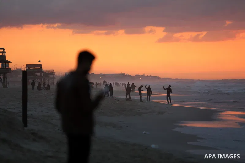 Palestinians enjoy their time on the beach of Gaza sea during sunset on December 24, 2021. The beach is one of the few open public spaces in this densely populated city. Photo by Ashraf Amra