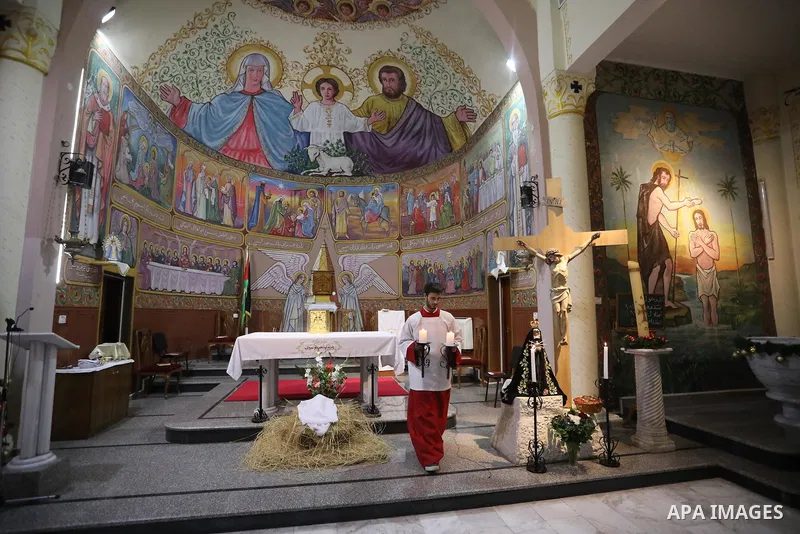 Palestinian Christians attend Christmas mass eve at the Roman Catholic Church of the Holy Family in Gaza City on December 24, 2021. Photo by Ashraf Amra