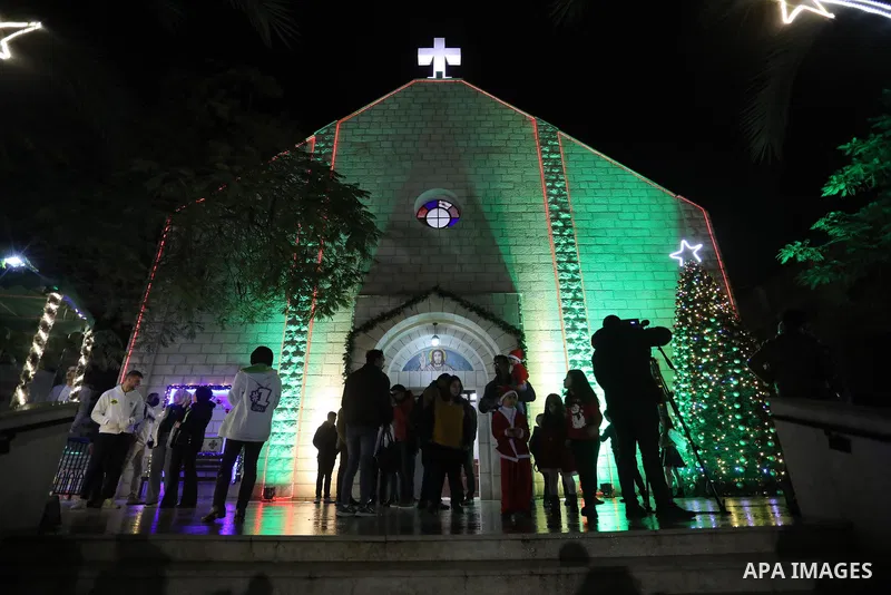 Palestinian Christians attend Christmas mass eve at the Roman Catholic Church of the Holy Family in Gaza City on December 24, 2021. Photo by Ashraf Amra