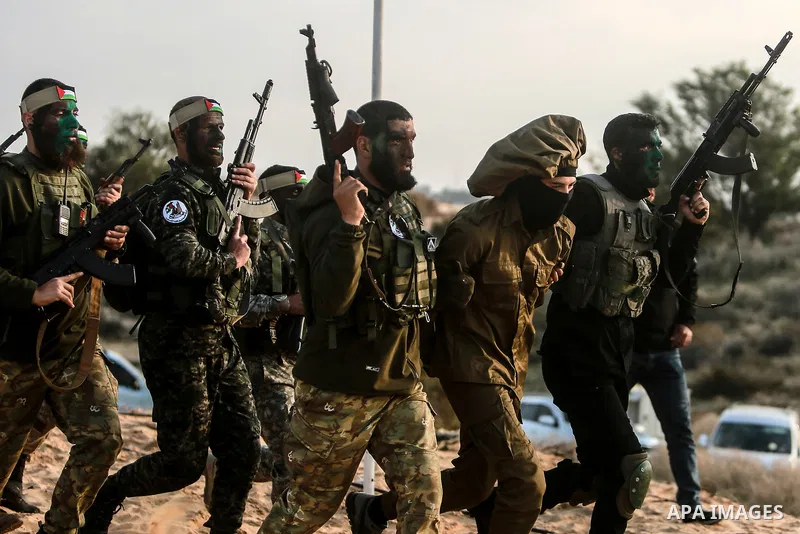 Palestinian factions militants take part in a joint military exercise, in Rafah in the southern of Gaza strip on December 29, 2021. Photo by Mohammed Dahman