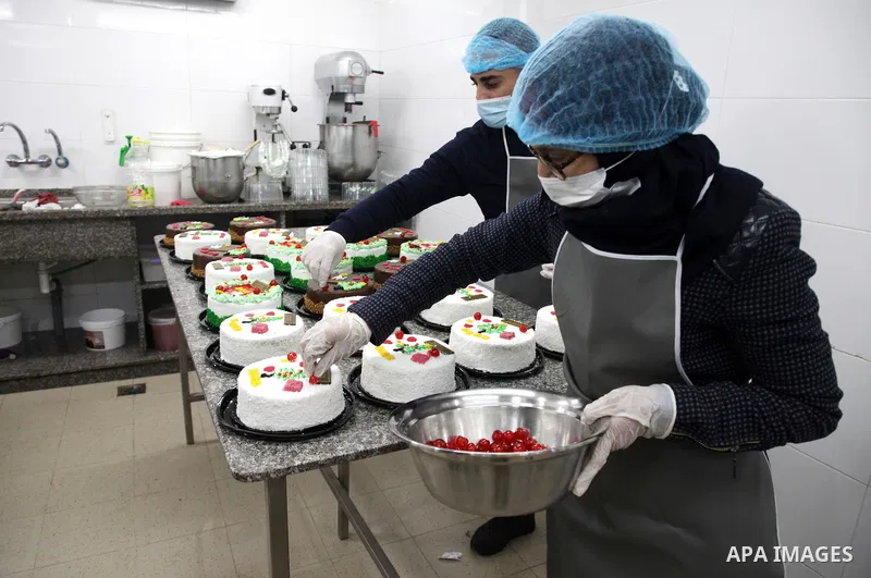 Palestinian chefs put final touches on cakes which portrays the new year number "2022", in Gaza city on December 30, 2021. Gazans hope for peace, prosperity in 2022 after the recent 11-day conflict between Israel and Ham...