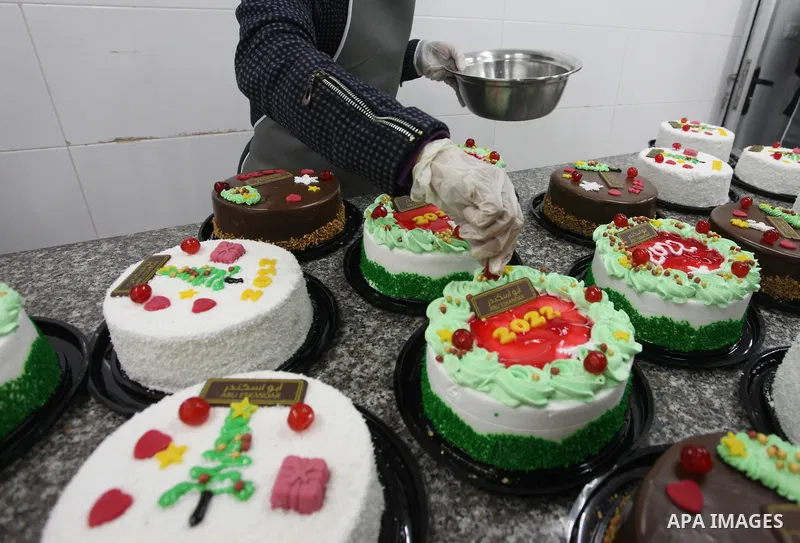 Palestinian chefs put final touches on cakes which portrays the new year number "2022", in Gaza city on December 30, 2021. Gazans hope for peace, prosperity in 2022 after the recent 11-day conflict between Israel and Ham...