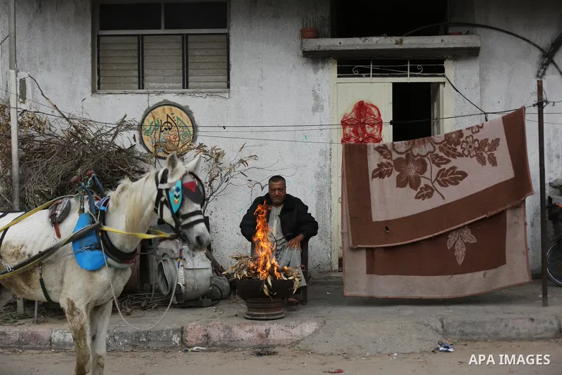 Palestinians show as they in their daily lifes during a rainy day, in Gaza City December 01, 2021. A low-pressure front is expected to affect Palestine today, thus weather conditions are set to be partly cloudy to cloudy...