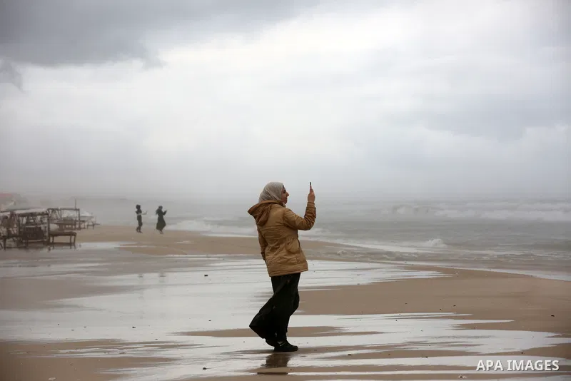 Palestinians show as they in their daily lives during a rainy day, in Gaza City December 01, 2021. A low-pressure front is expected to affect Palestine today, thus weather conditions are set to be partly cloudy to cloudy...