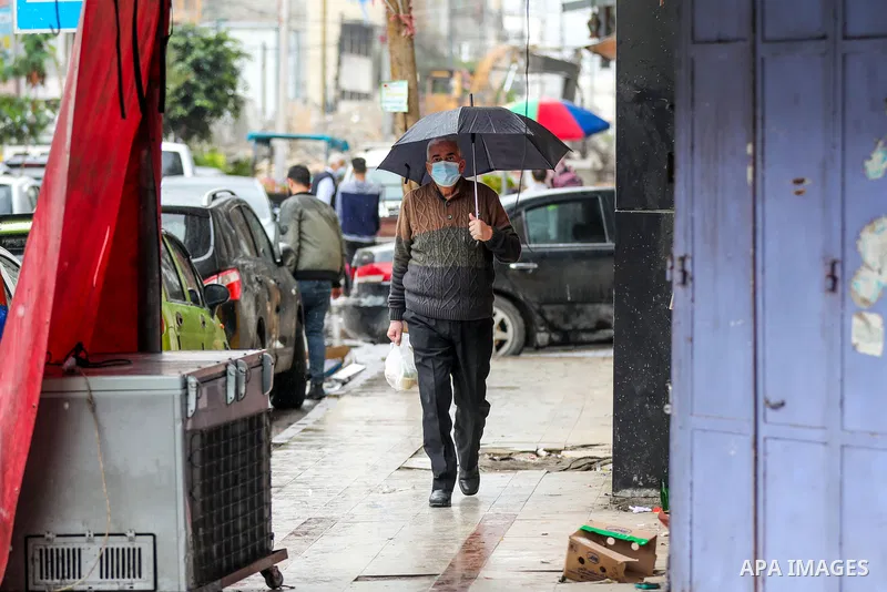 Palestinians show as they in their daily lifes during a rainy day, in Gaza City December 01, 2021. A low-pressure front is expected to affect Palestine today, thus weather conditions are set to be partly cloudy to cloudy...