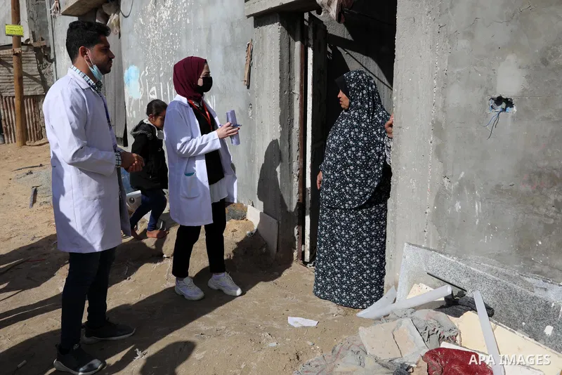 Palestinian youths take part in a campaign to encourage people to get vaccinated against COVID-19, in Gaza city on December 2, 2021. Three people have died of coronavirus in the Gaza Strip and one person in the West Bank...