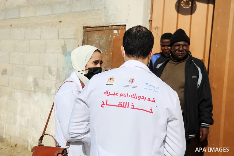 Palestinian youths take part in a campaign to encourage people to get vaccinated against COVID-19, in Gaza city on December 2, 2021. Three people have died of coronavirus in the Gaza Strip and one person in the West Bank...